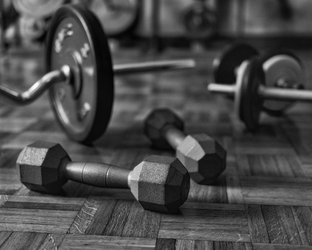 Close up of gym equipment and weights in dark room