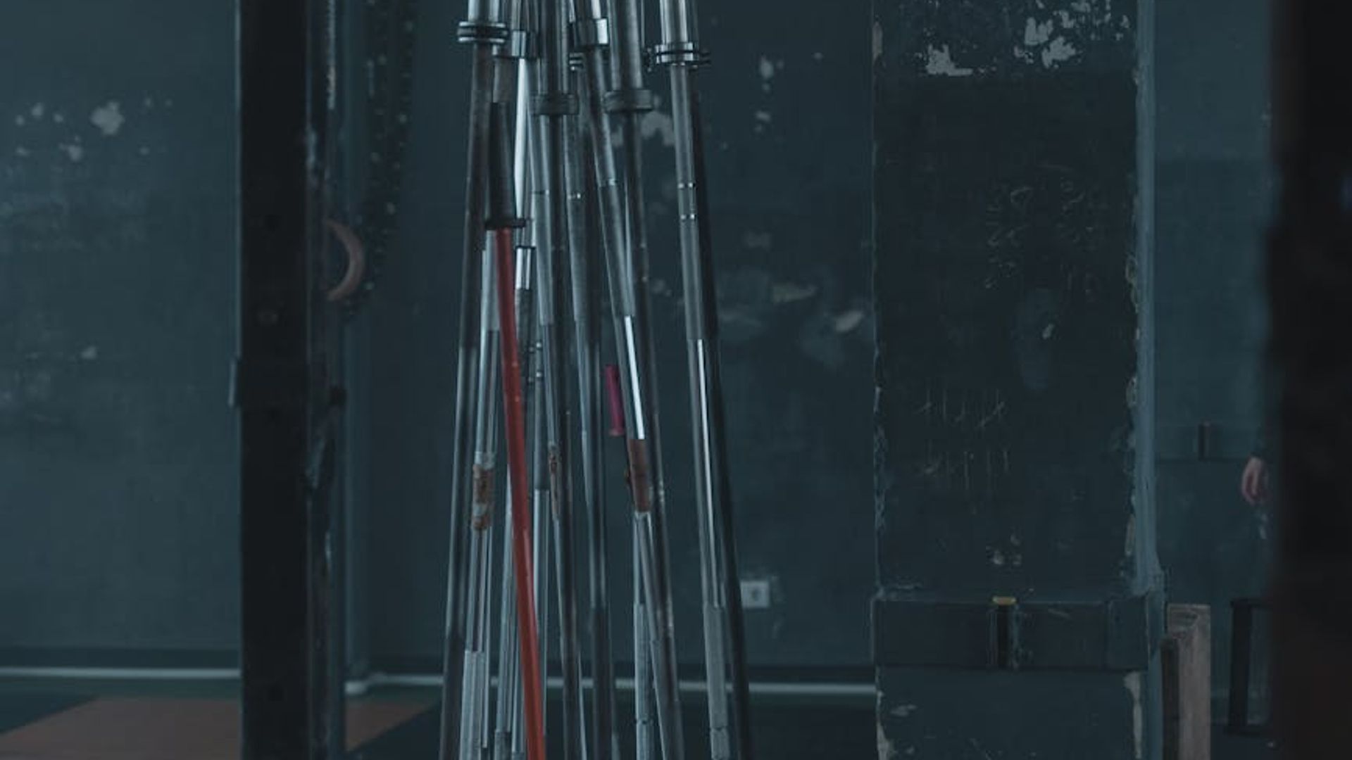 Strong man training in a dark industrial gym environment